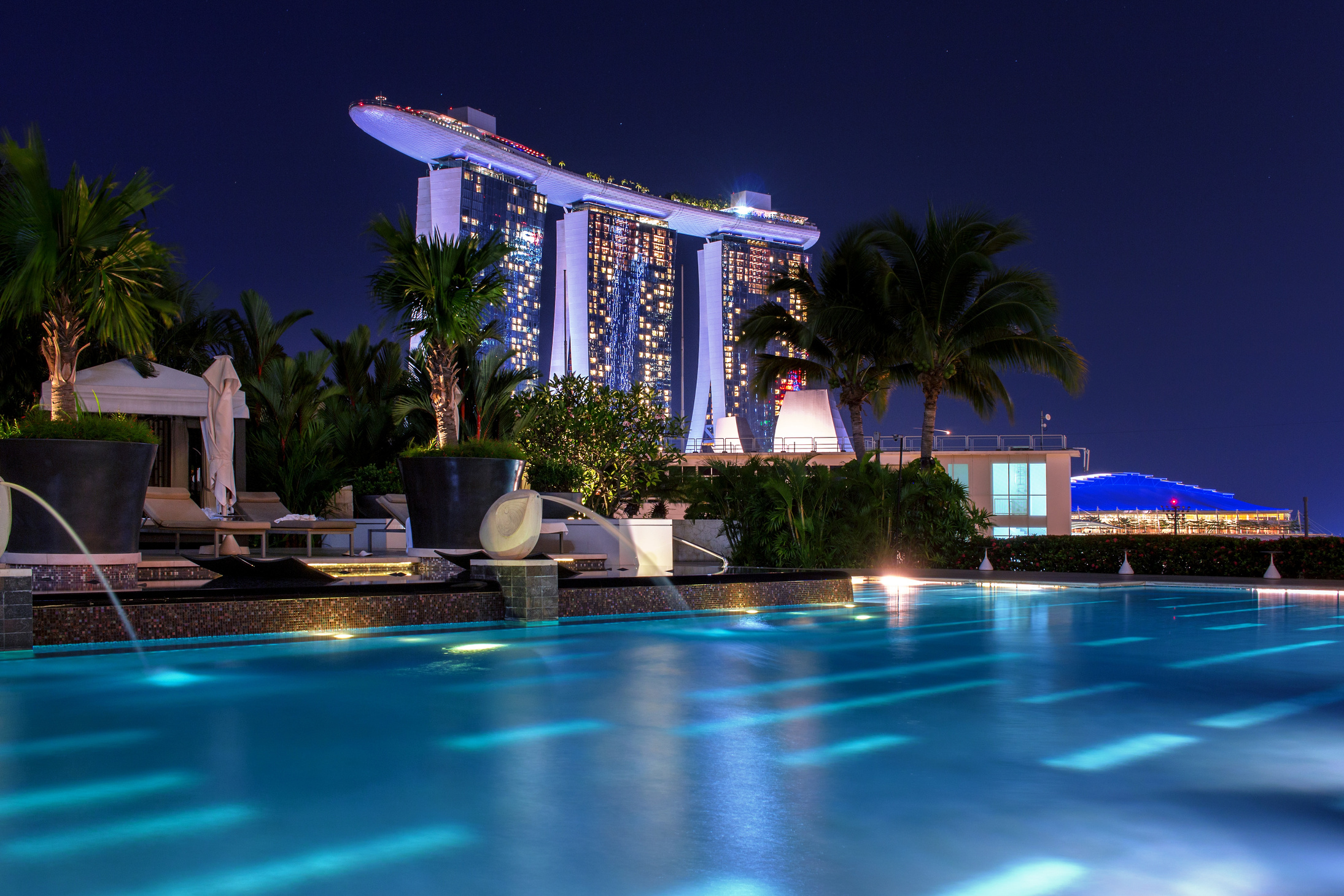 Singapore Building At Night From a Luxury Pool